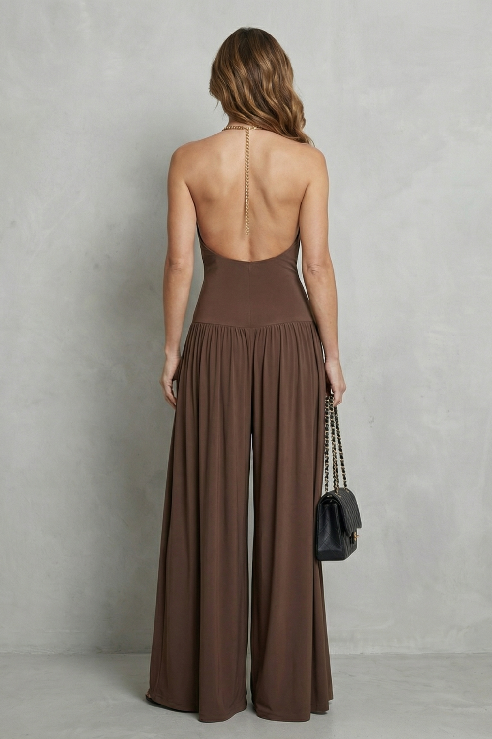 Detail close-up of the halter neckline metal ring and cowl drape bodice