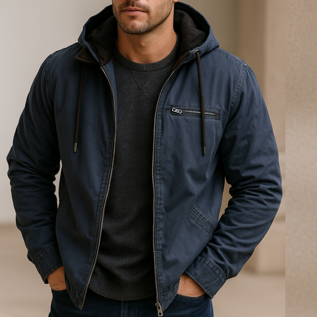 Man wearing a navy blue jacket with a hood on a beige background