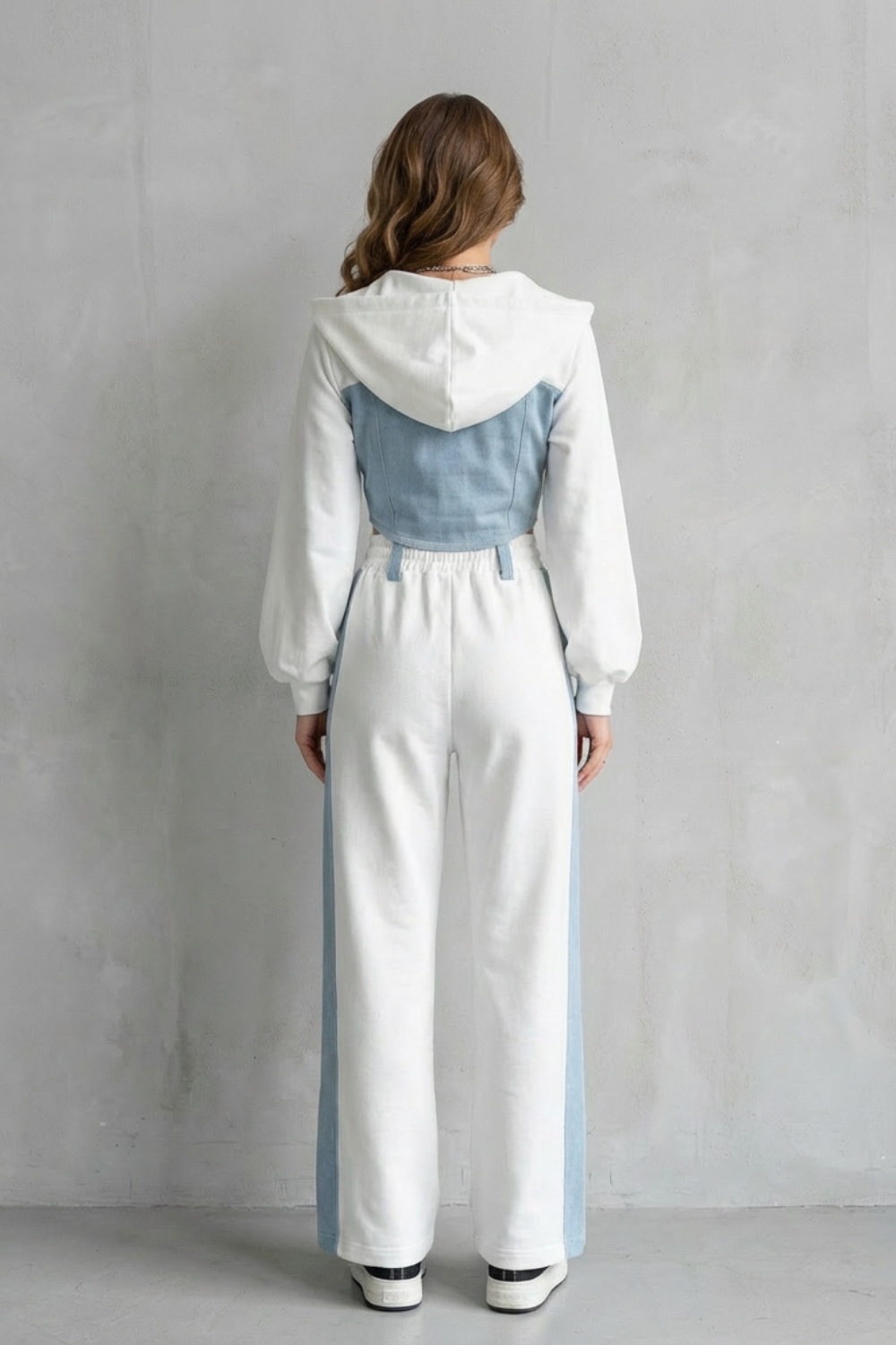 Detail close-up of the corset-inspired denim paneling on the hoodie