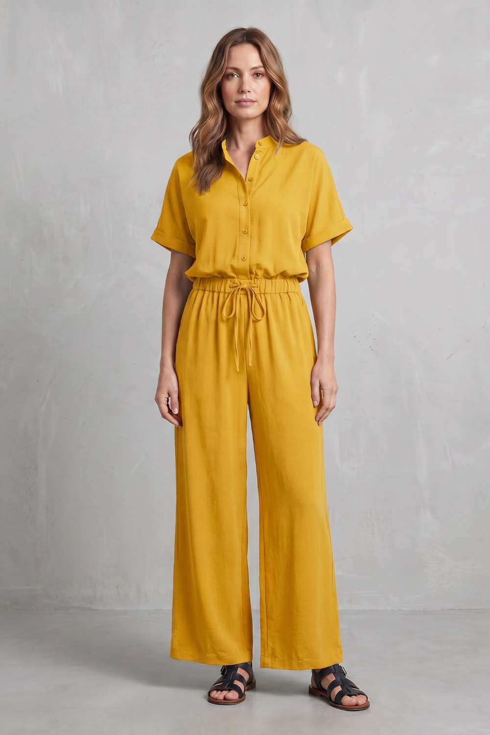 Wide-leg pants set styled with flat sandals and a woven tote