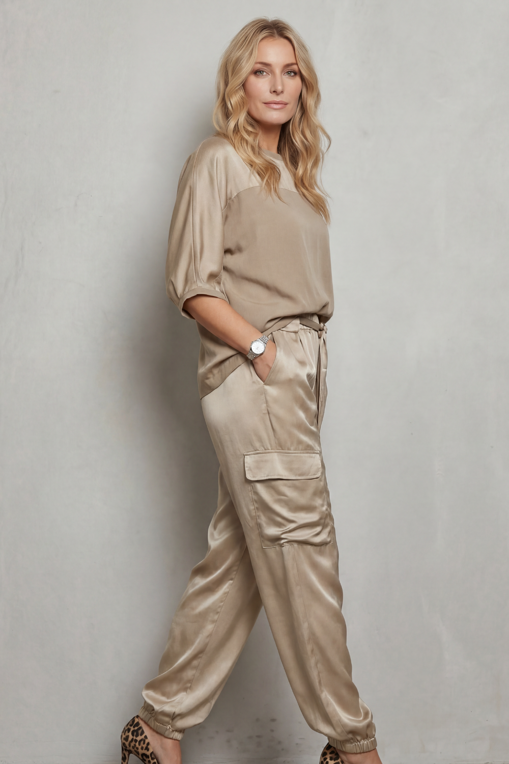 Back view of the relaxed-fit satin lounge top and cargo pants