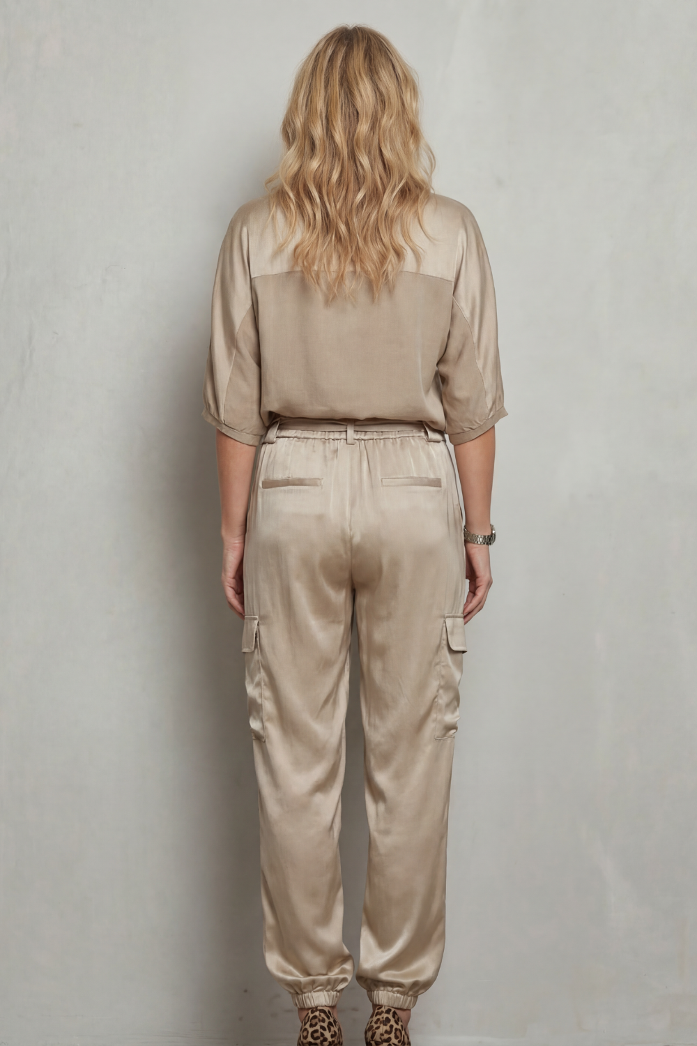 Detail close-up of the utility cargo pockets on the satin lounge pants