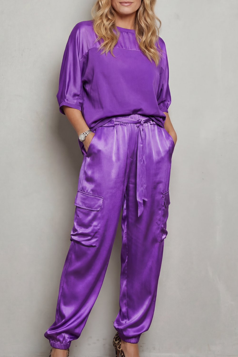 Detail close-up of the drawstring waist on the satin cargo pants