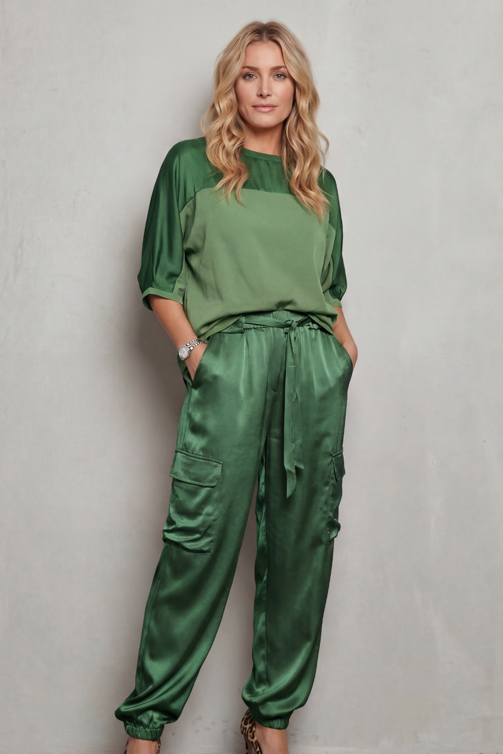 Green colorway of the satin top and cargo pants set, full-length view