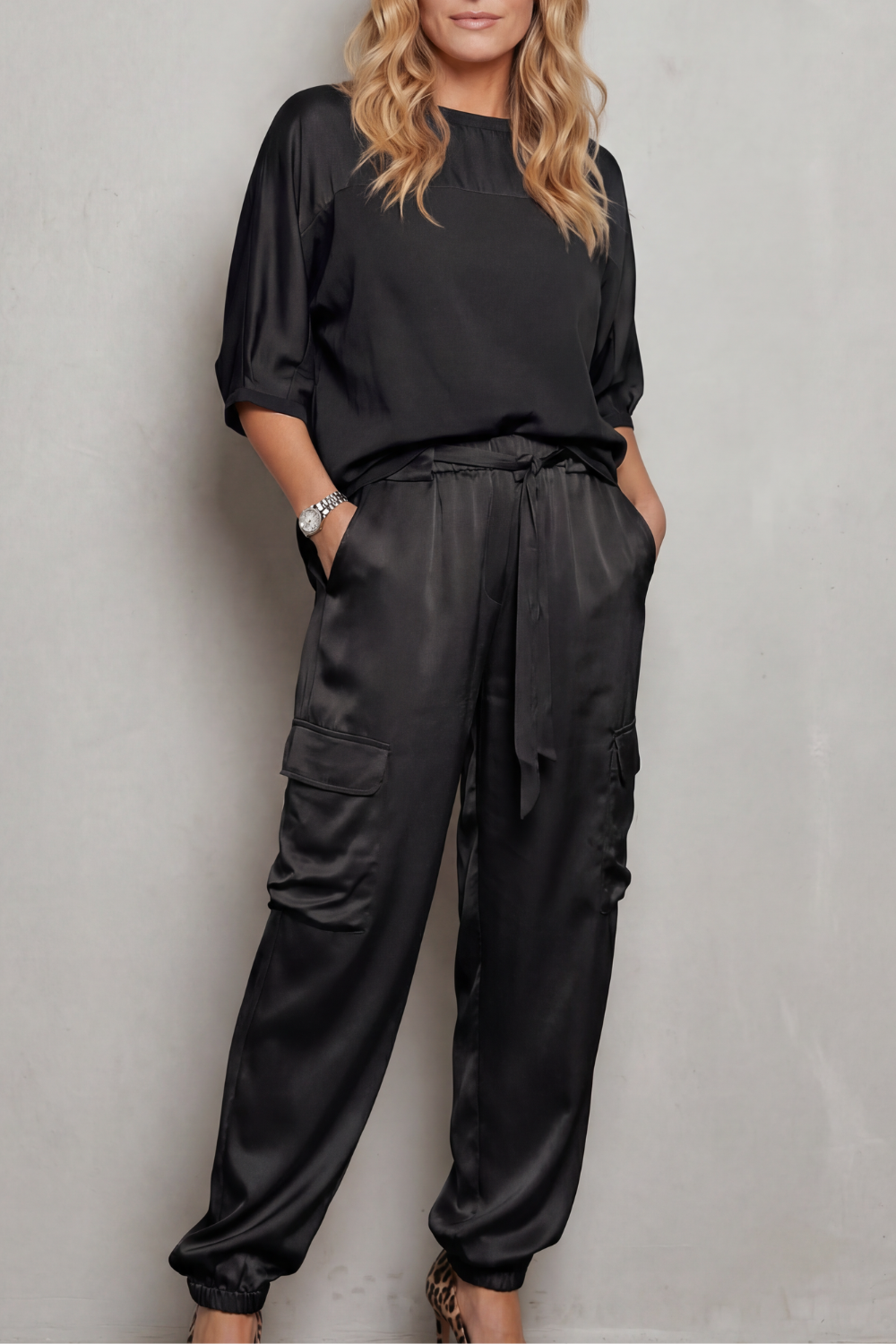 Black colorway of the satin cargo pants lounge set, full-length view