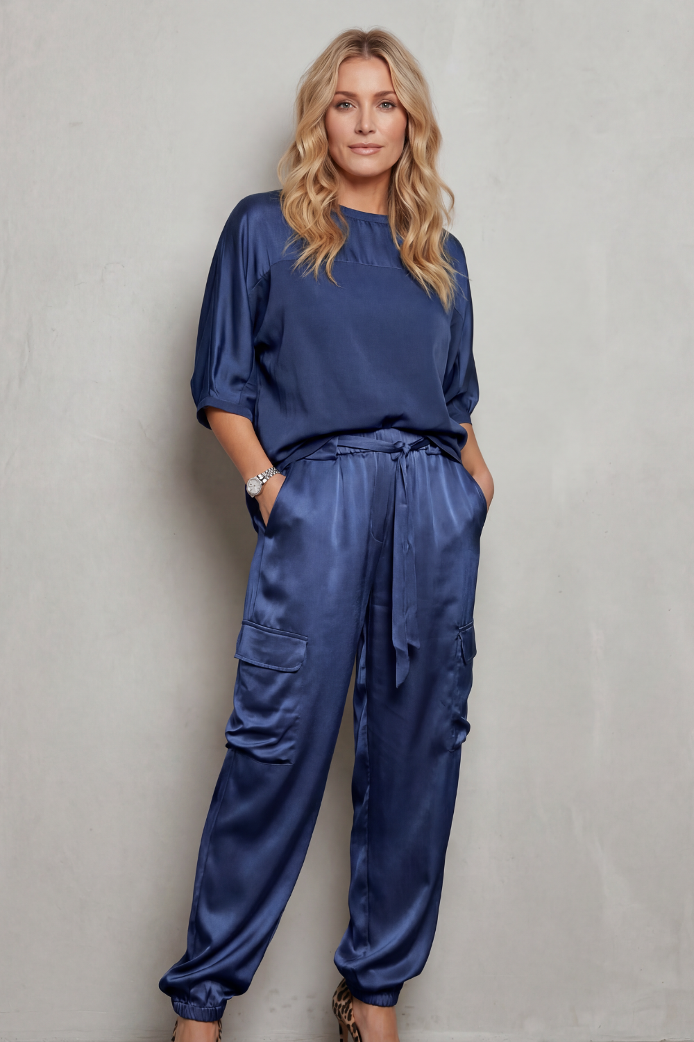 Close-up of the tapered ankle cuff on the satin cargo pants