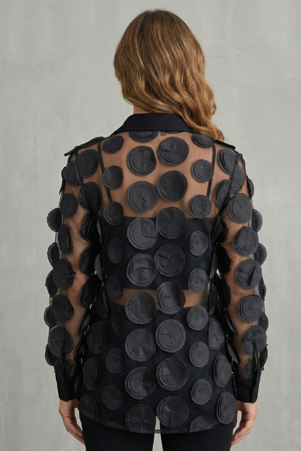 Detail close-up of the 3D floral applique on the mesh overlay