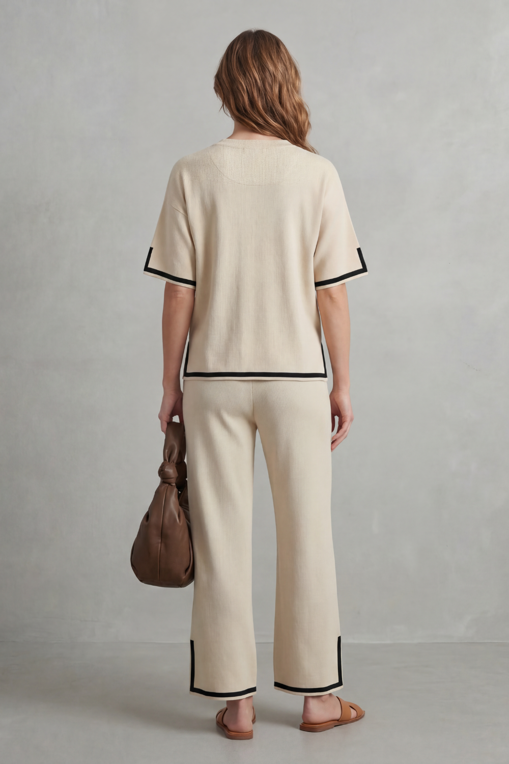 Detail close-up of the bold contrast hem on the rib-knit top