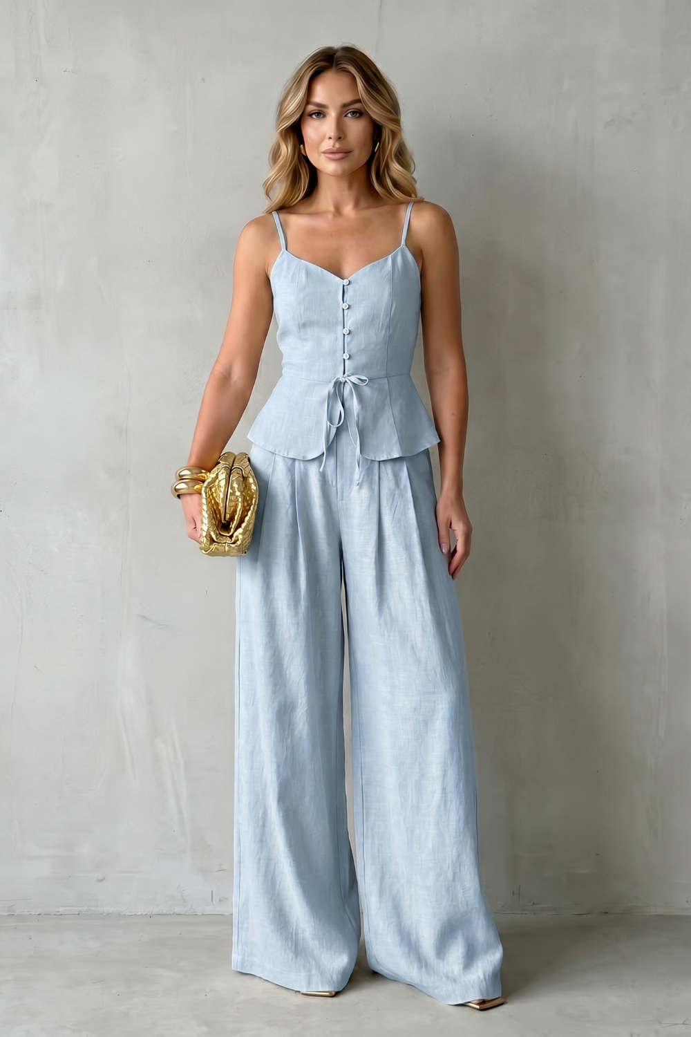 Close-up of the high-waisted waistband and wide-leg drape of the pants
