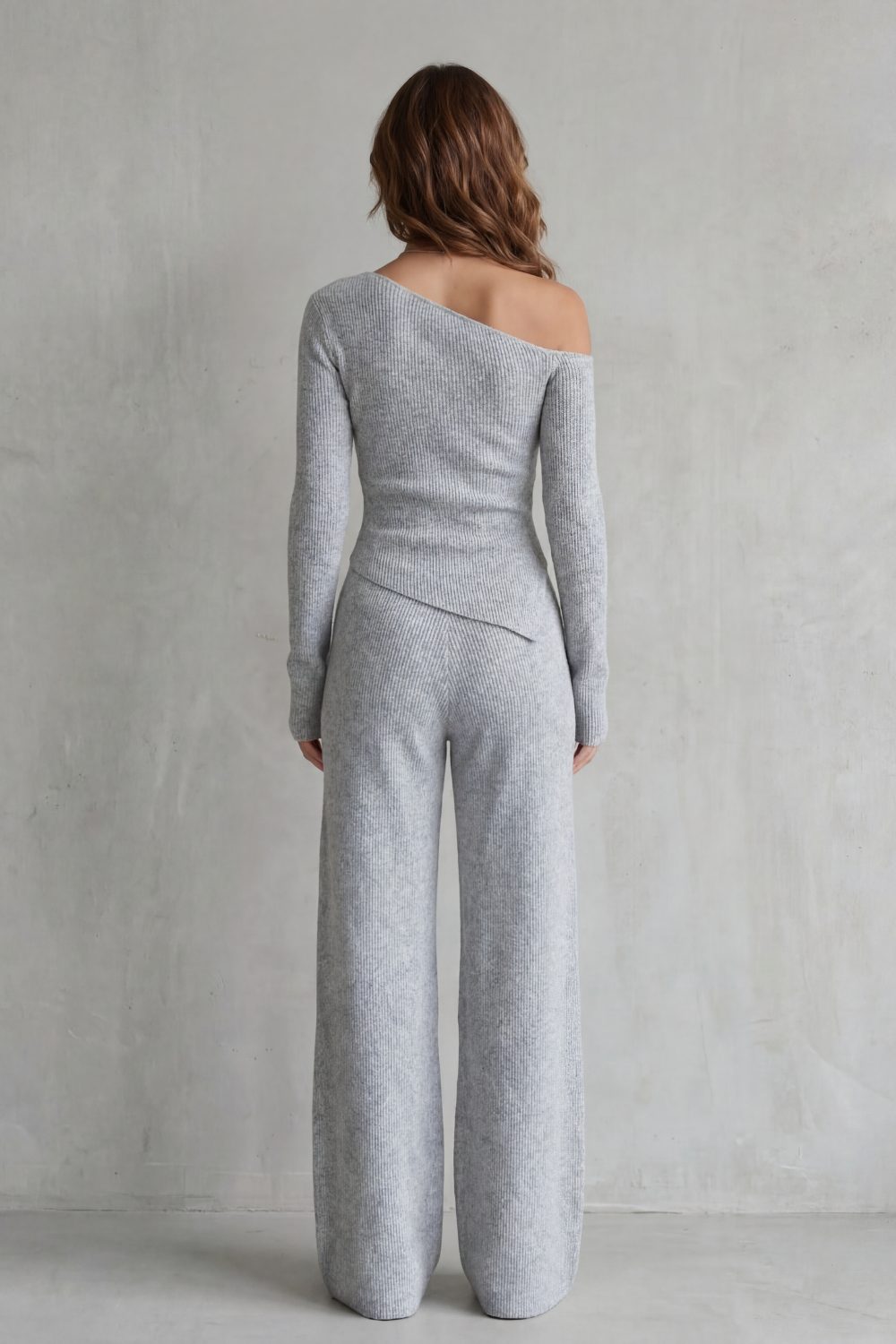Detail close-up of the ribbed knit texture and off-shoulder neckline