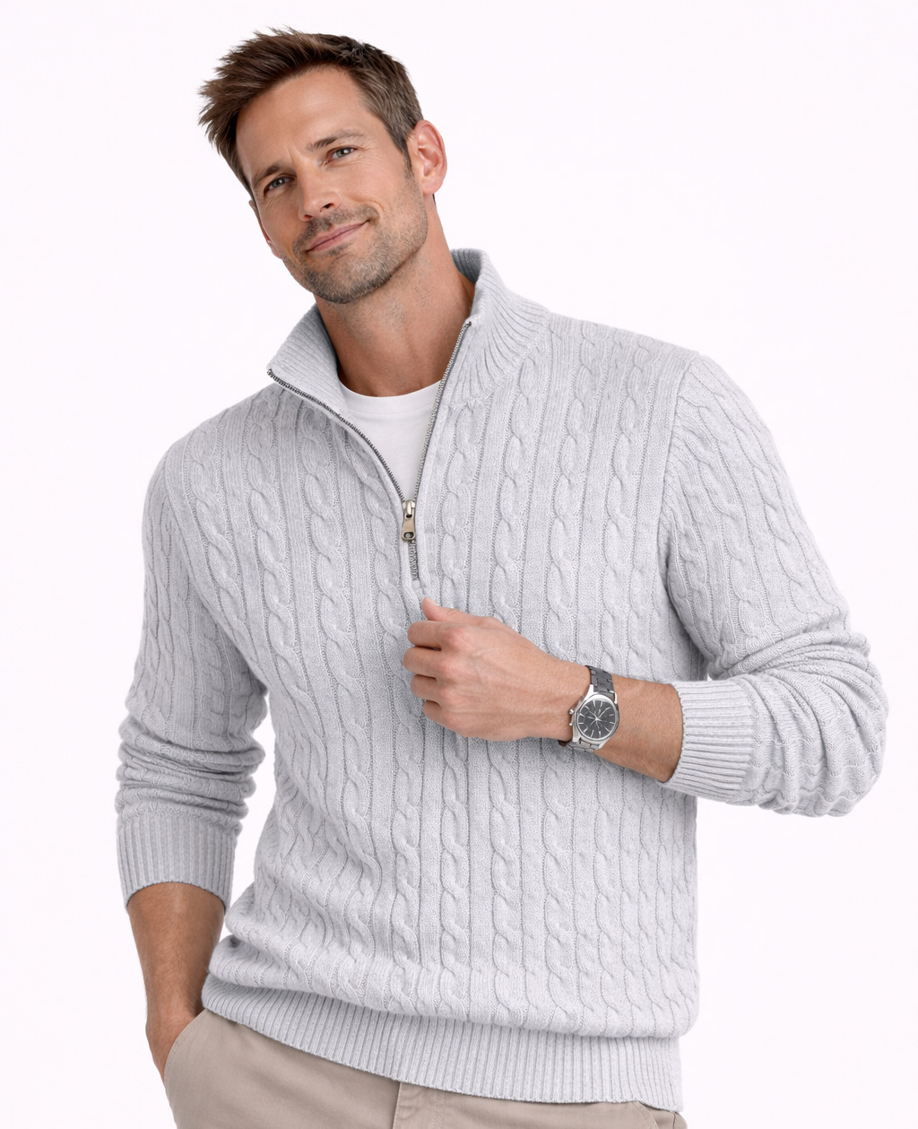 Man wearing a light gray cable knit sweater with a zipper on a white background