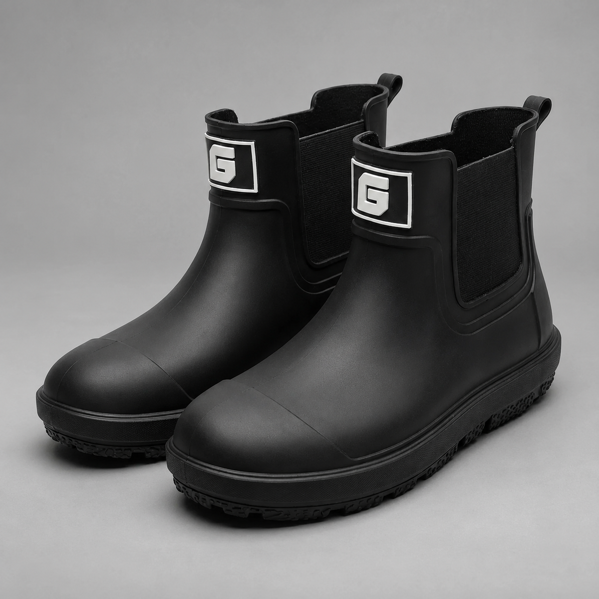 Men’s waterproof ankle boots with an easy pull-on design, durable rubber outsole, and slip-resistant tread for wet-weather wear.
