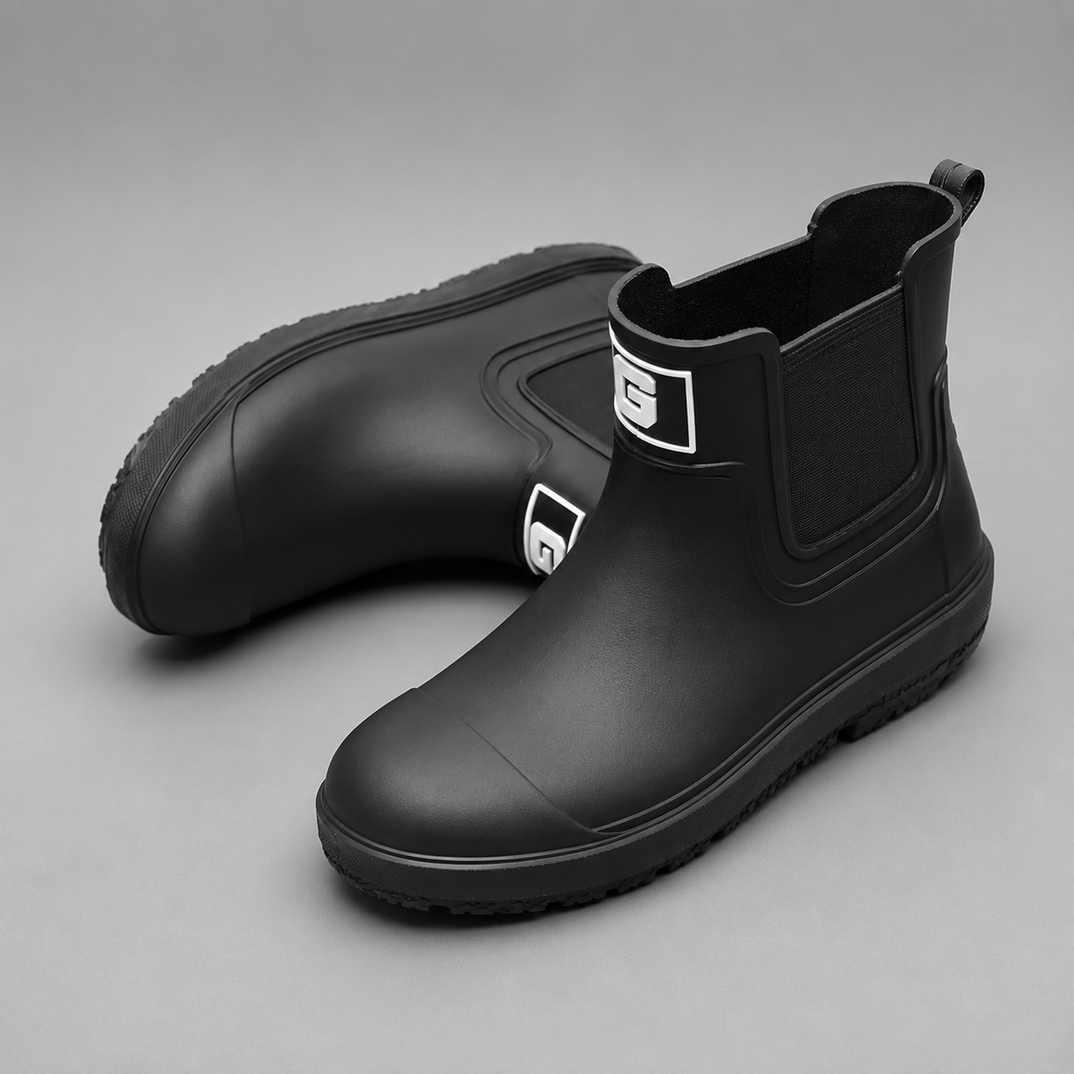 Men’s waterproof ankle boots with an easy pull-on design, durable rubber outsole, and slip-resistant tread for wet-weather wear.