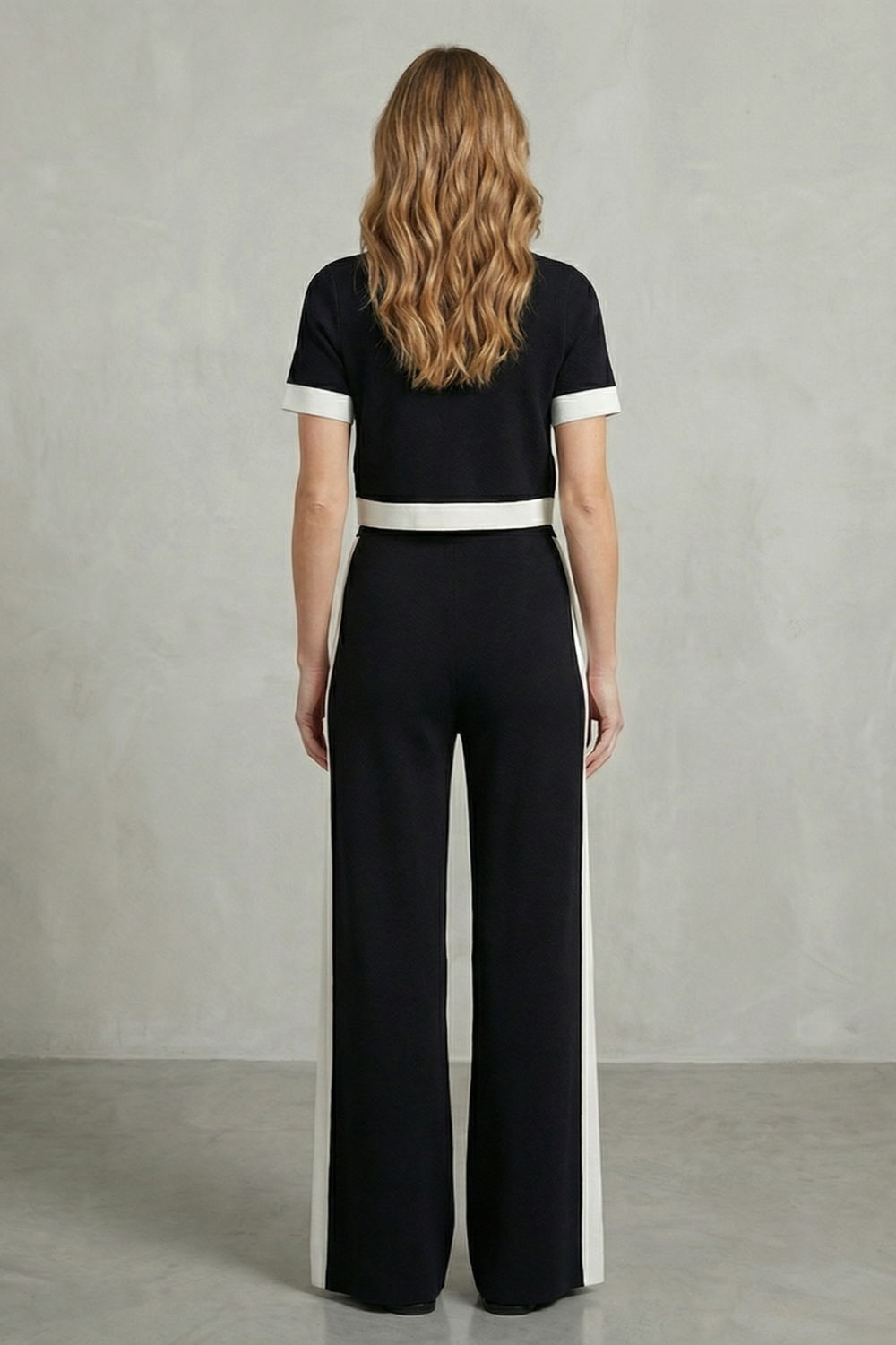 Black colorway of the cropped top and wide-leg pants set, full-length view