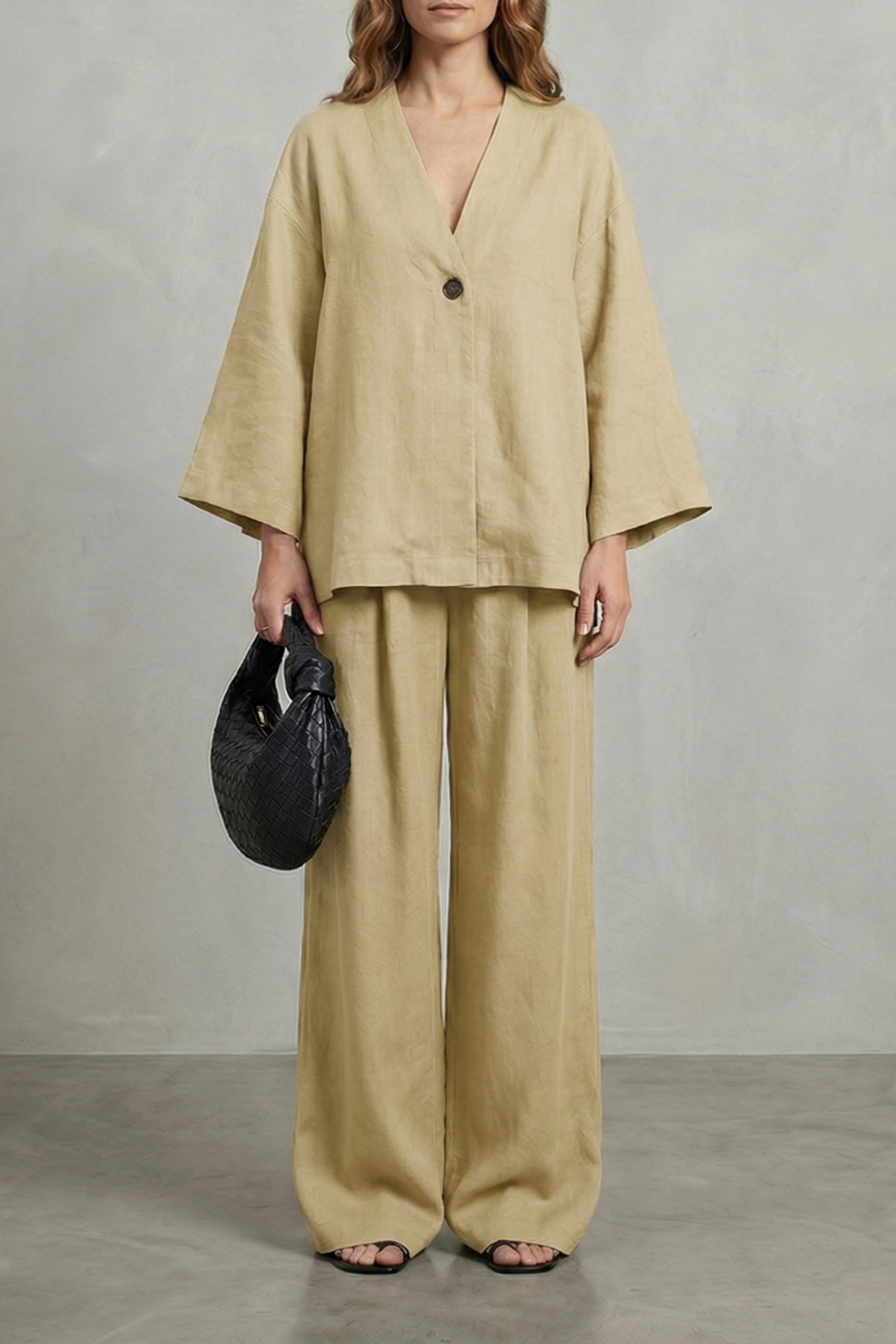 Wrap top and wide-leg pants set styled with minimal heels and a structured bag
