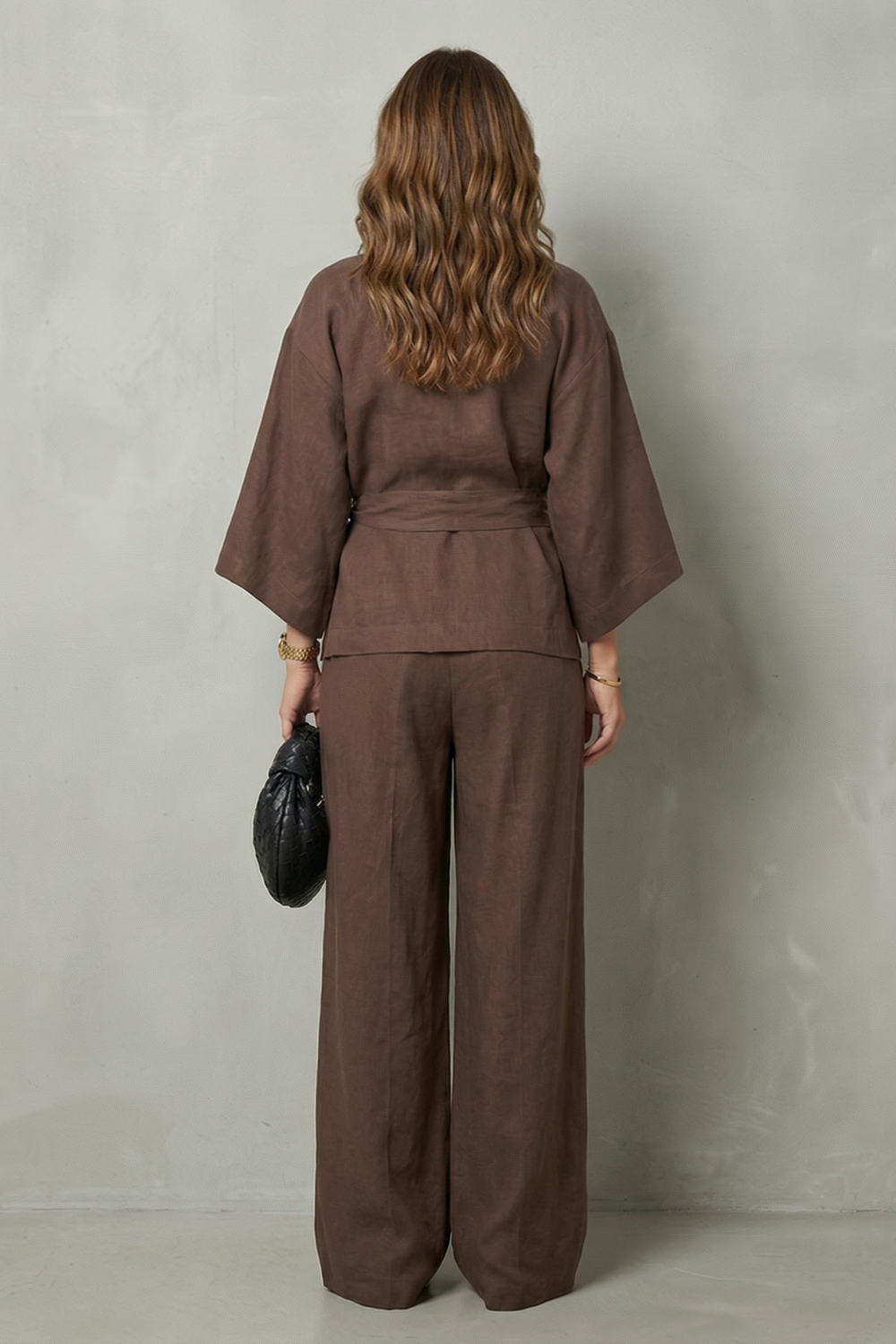 Detail close-up of the wrap V-neckline and draped sleeve