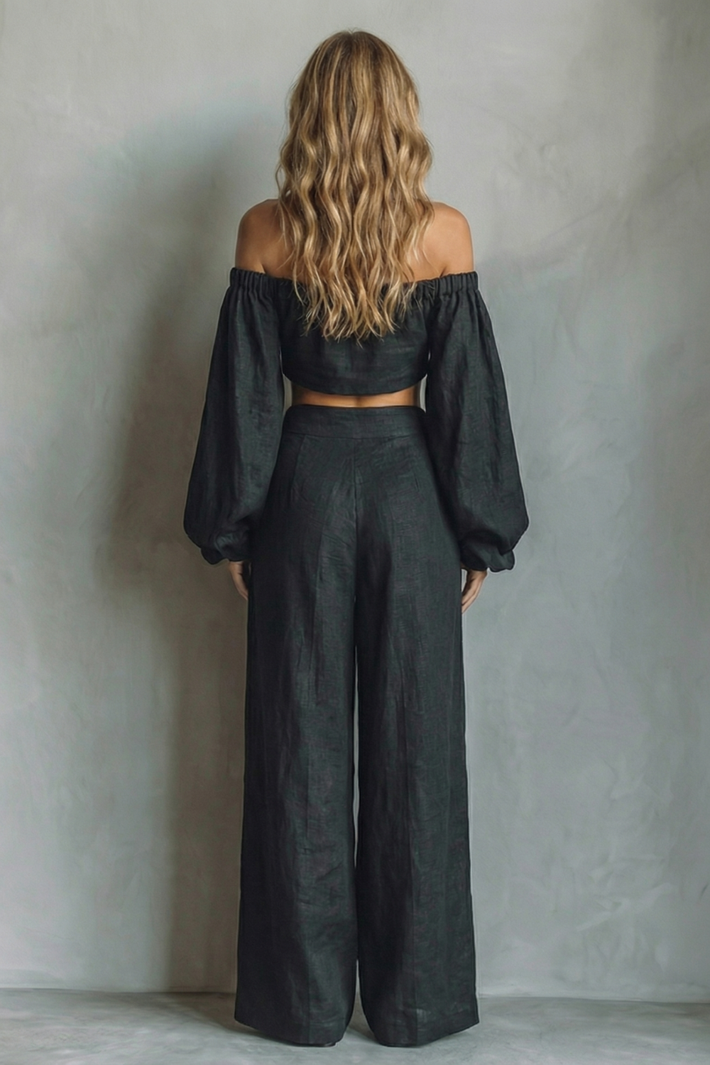 Detail close-up of the voluminous long sleeves and off-shoulder neckline