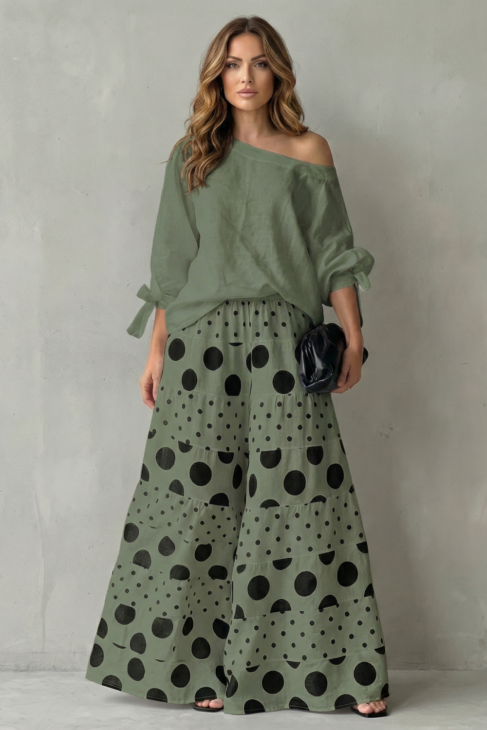 Orange colorway of the polka dot top and wide-leg pants set, full-length view