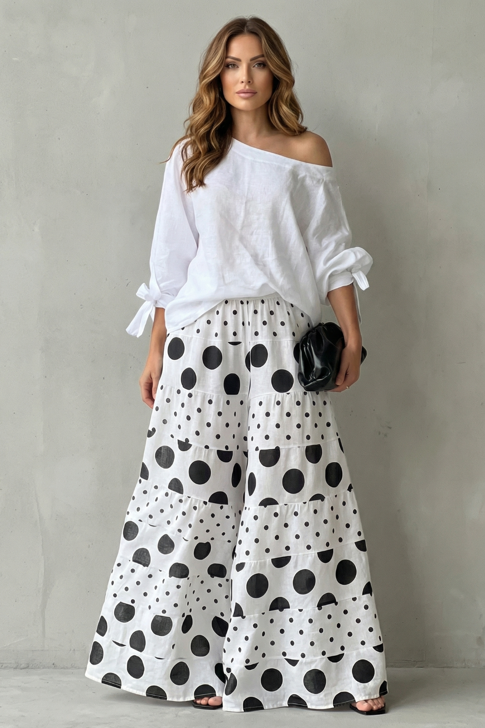 Side view of the polka dot off-shoulder top and flowing wide-leg pants