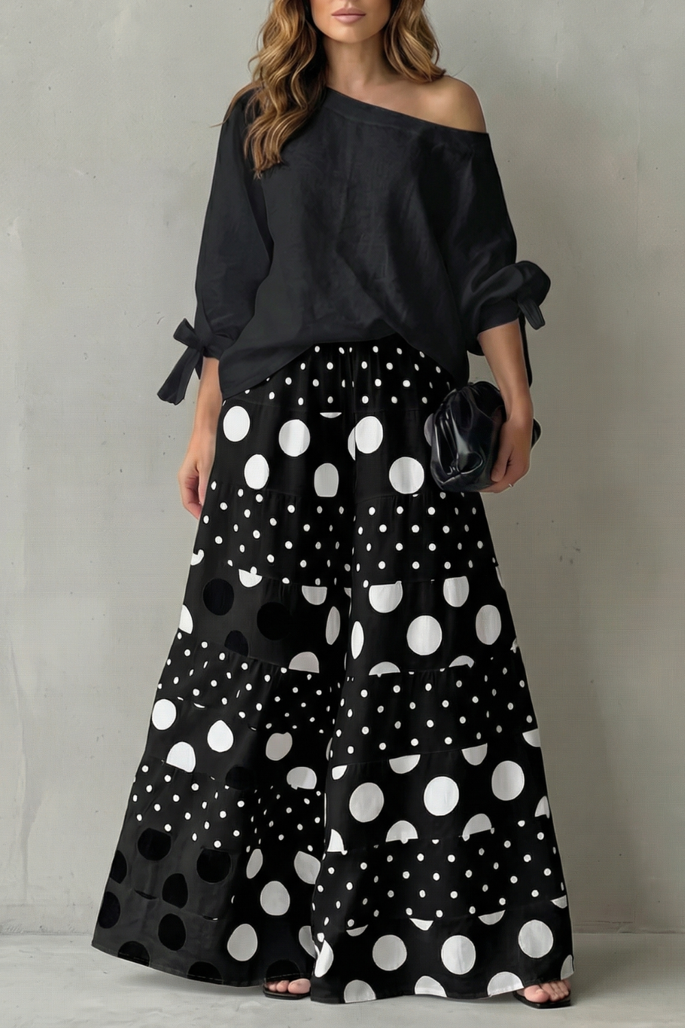 Detail close-up of the polka dot print and side pocket on the wide-leg pants