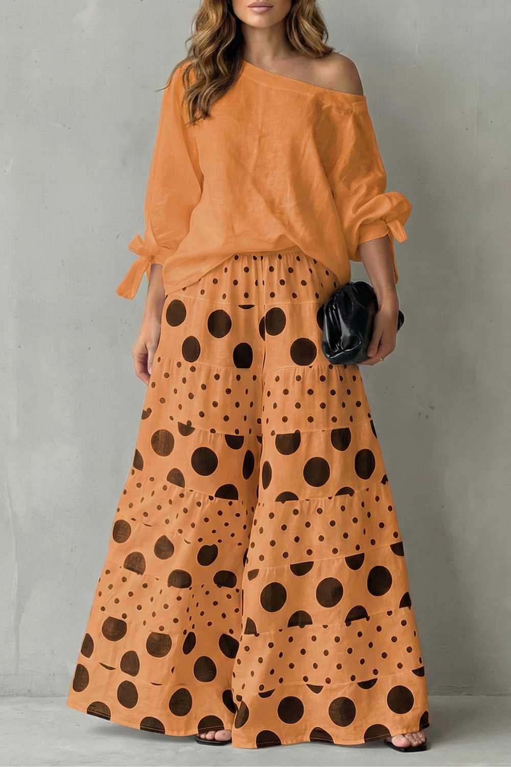 Polka dot two-piece set styled with sandals and a clutch for daytime