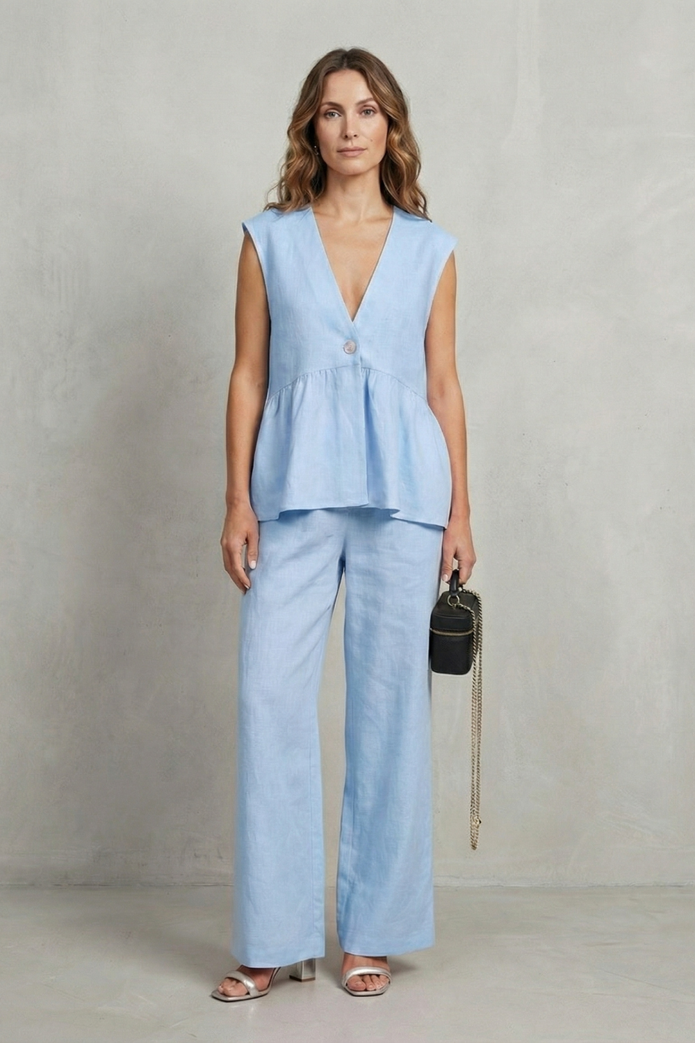Pink colorway of the ruffle top and straight-leg pants set, full-length view