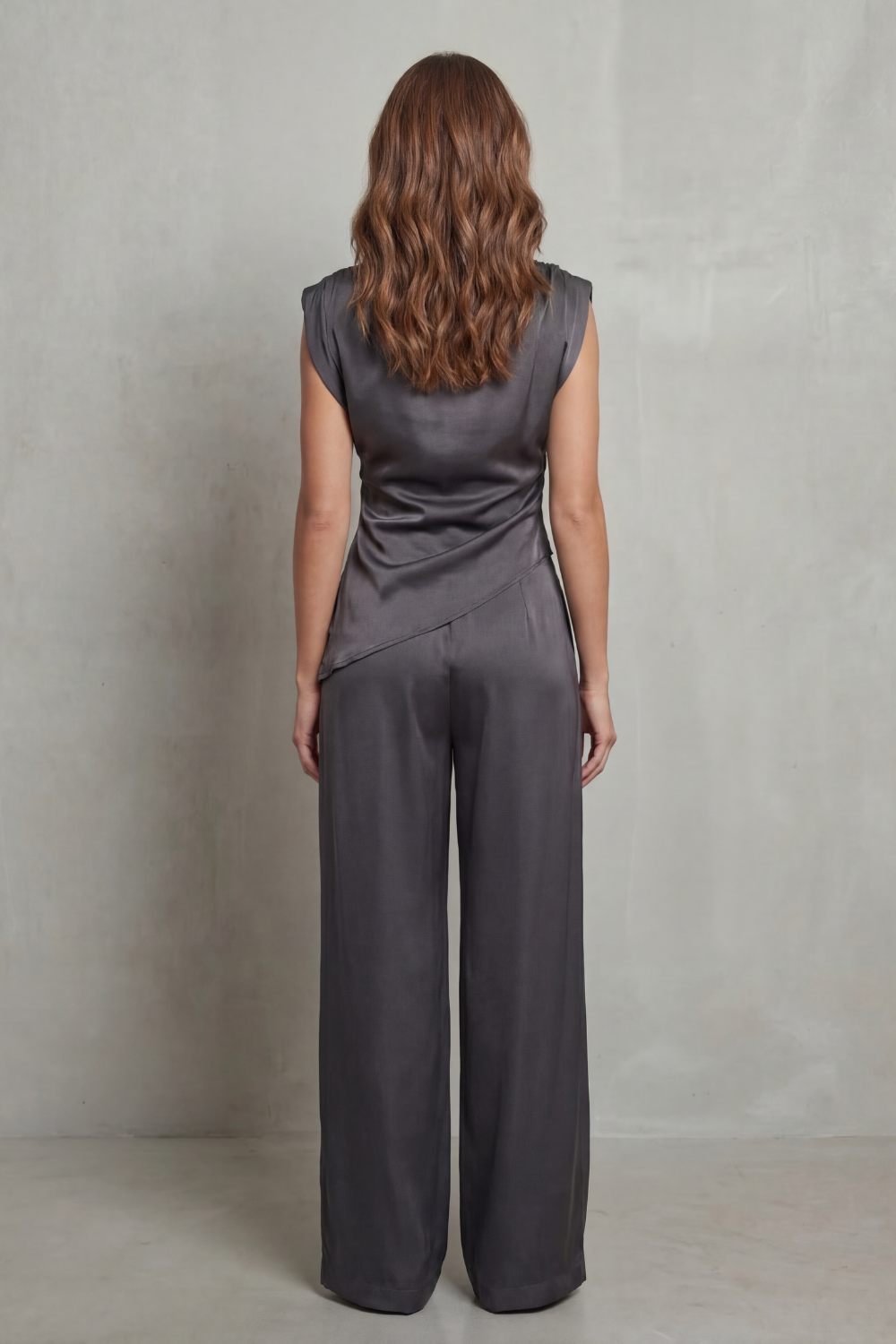 Detail close-up of the asymmetric draped waist detail