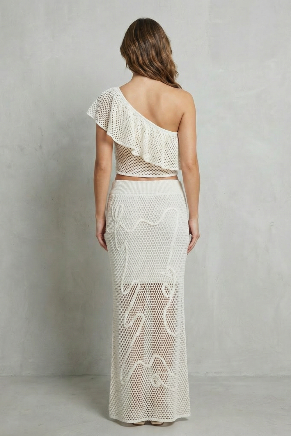Detail close-up of the openwork knit texture and ruffle trim