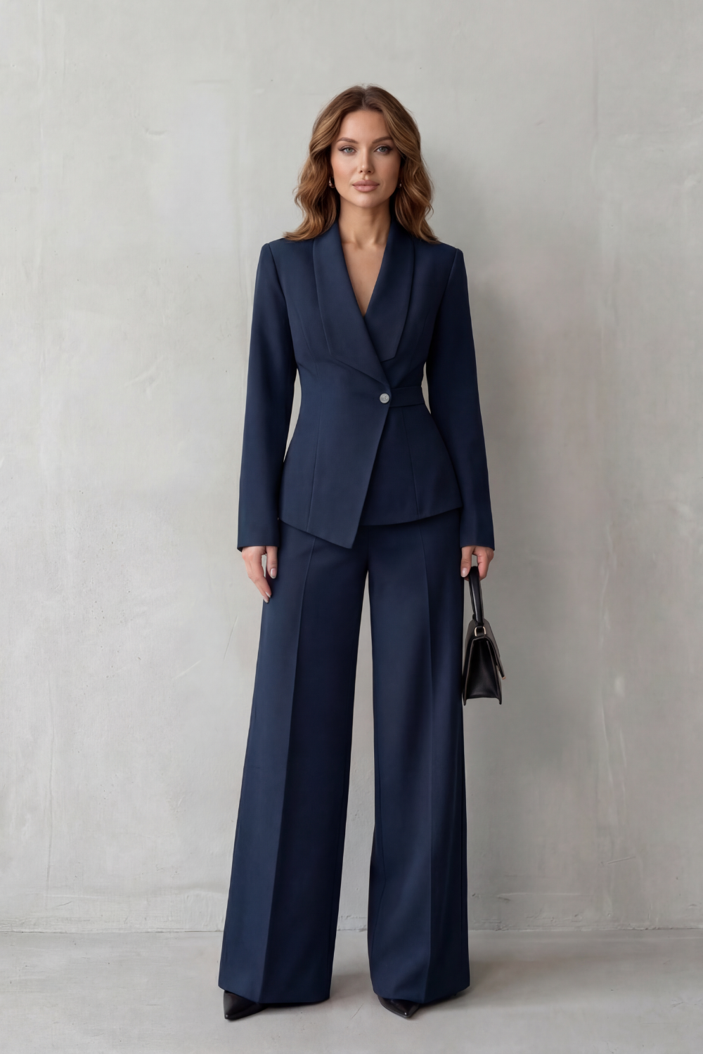 Three-quarter view of the sculpted-waist blazer and wide-leg pants