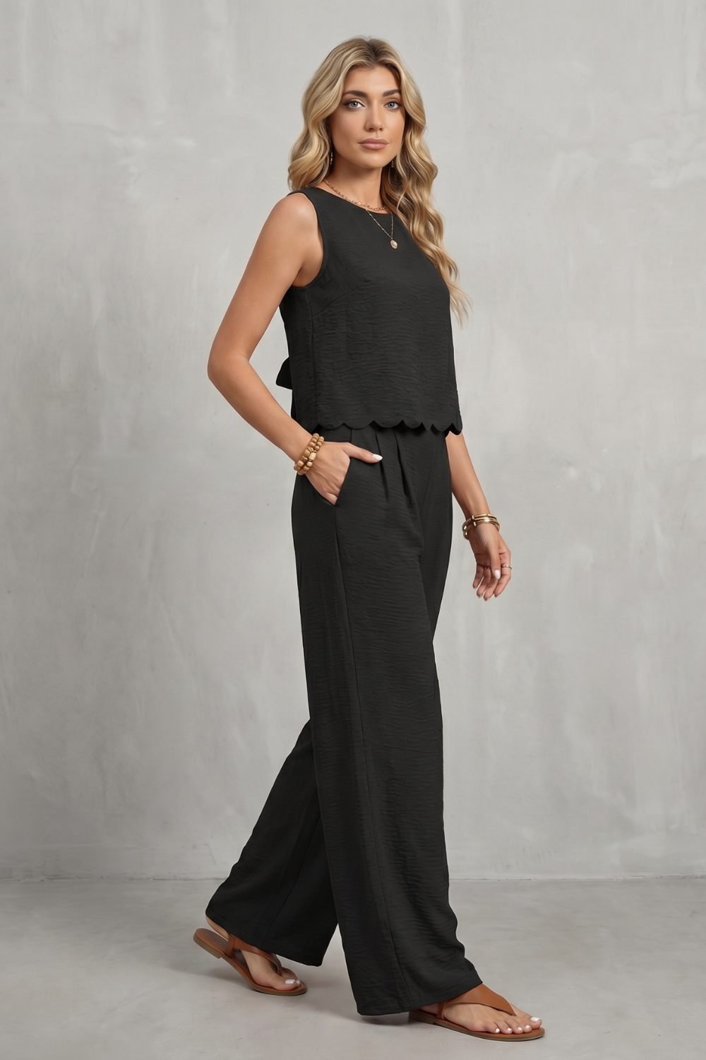 Side view of the open-back top and flowing wide-leg pants