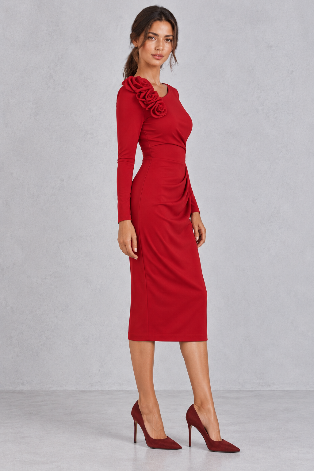 Front view of a ruched bodycon midi dress with a single long sleeve and 3D rose detail.