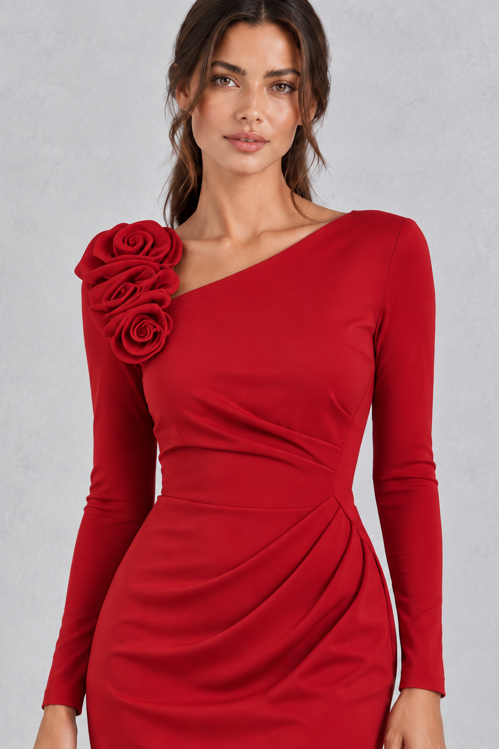 Close-up of the 3D rose decoration on a one shoulder midi dress for wedding guests.