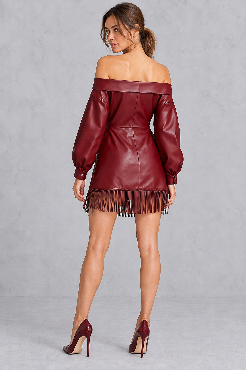 Back view of a women's faux leather mini dress with zip closure