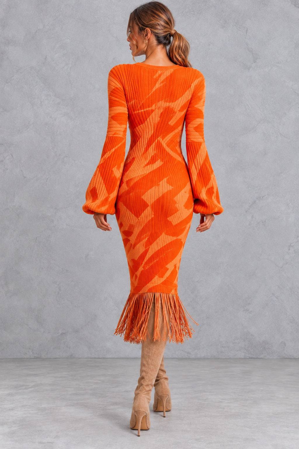 Women's long sleeve V-neck sweater dress in an orange abstract print