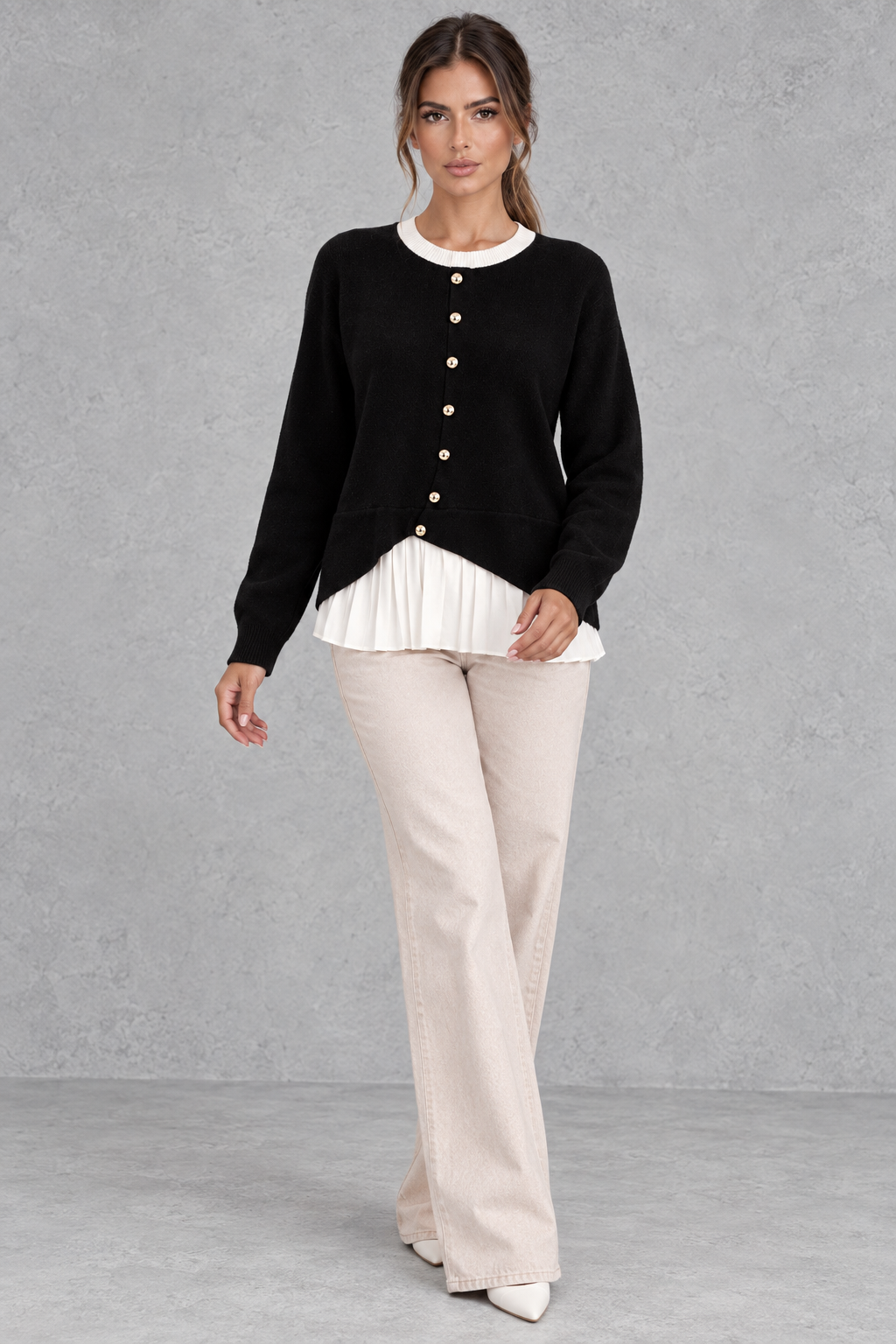 Close-up of gold-tone buttons and contrast ribbed neckline