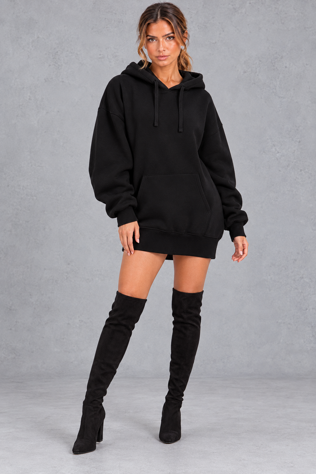 Women's oversized sweatshirt mini dress styled with sneakers for everyday wear