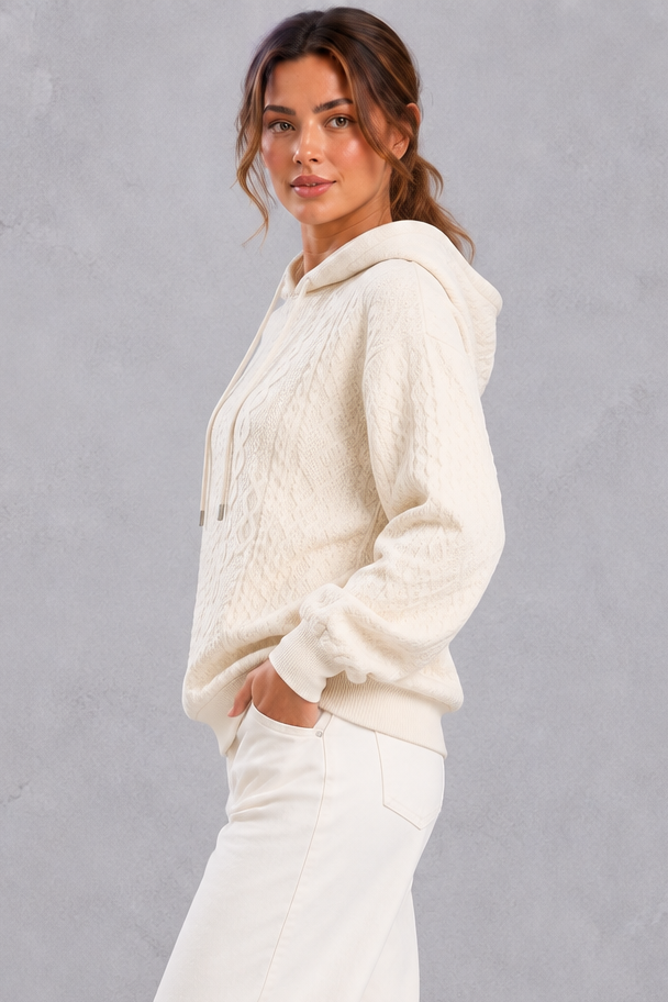 Plus size cable knit hooded sweater styled with jeans