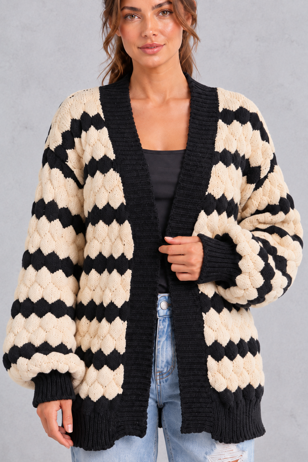 Close-up of bubble-textured knit and black ribbed trim