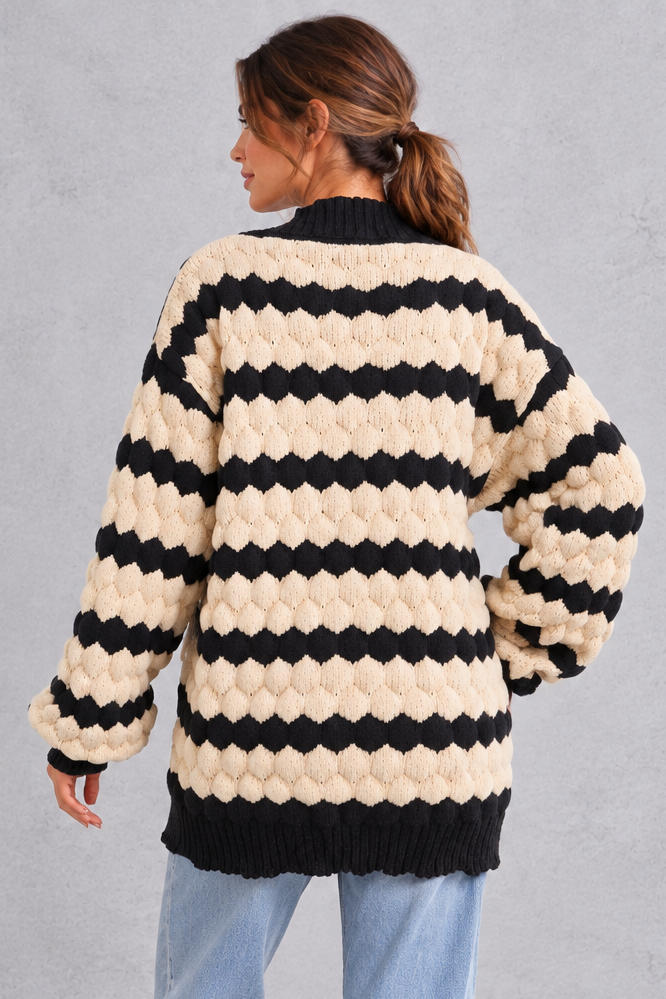 Side view showing voluminous puff sleeve and ribbed cuff