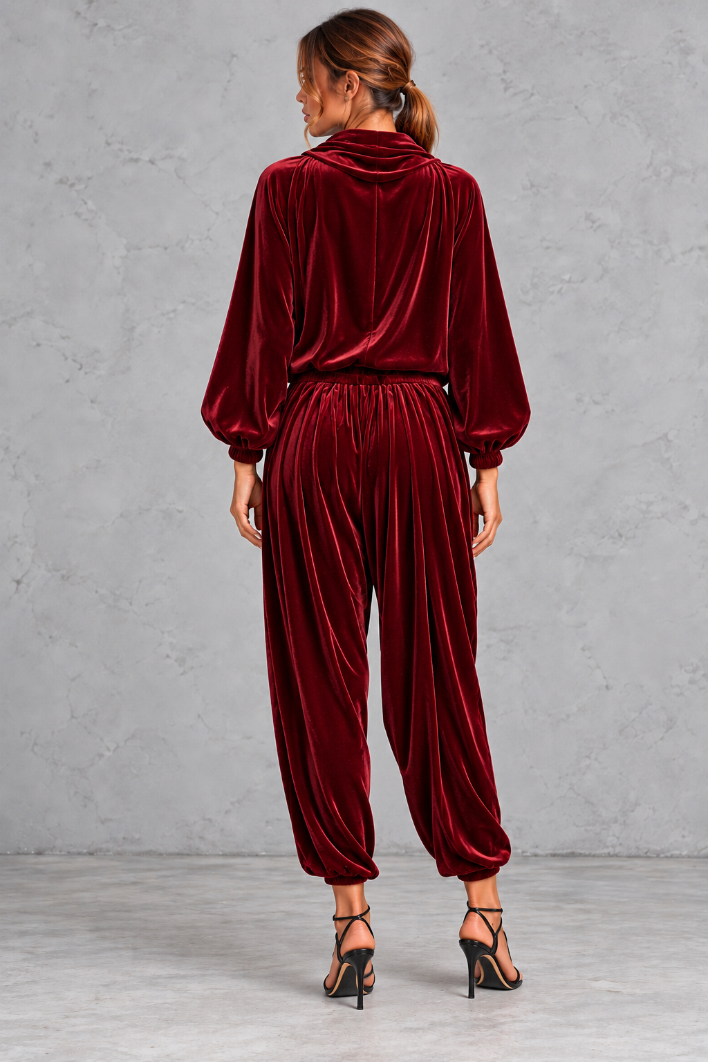 Detail close-up of the draped cowl neckline and soft velvet sheen