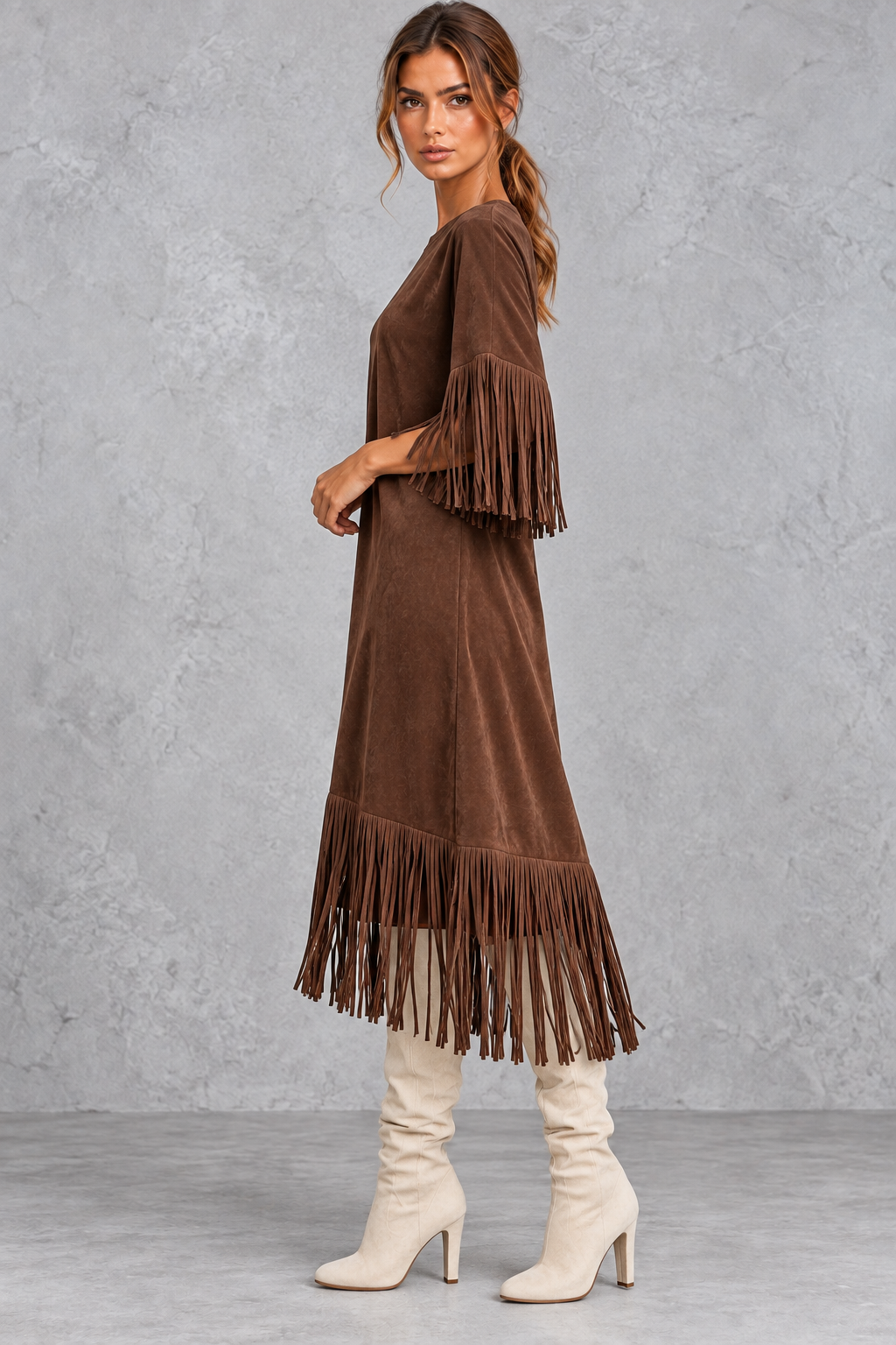 Women's faux suede fringe dress styled with tall boots for a Western look