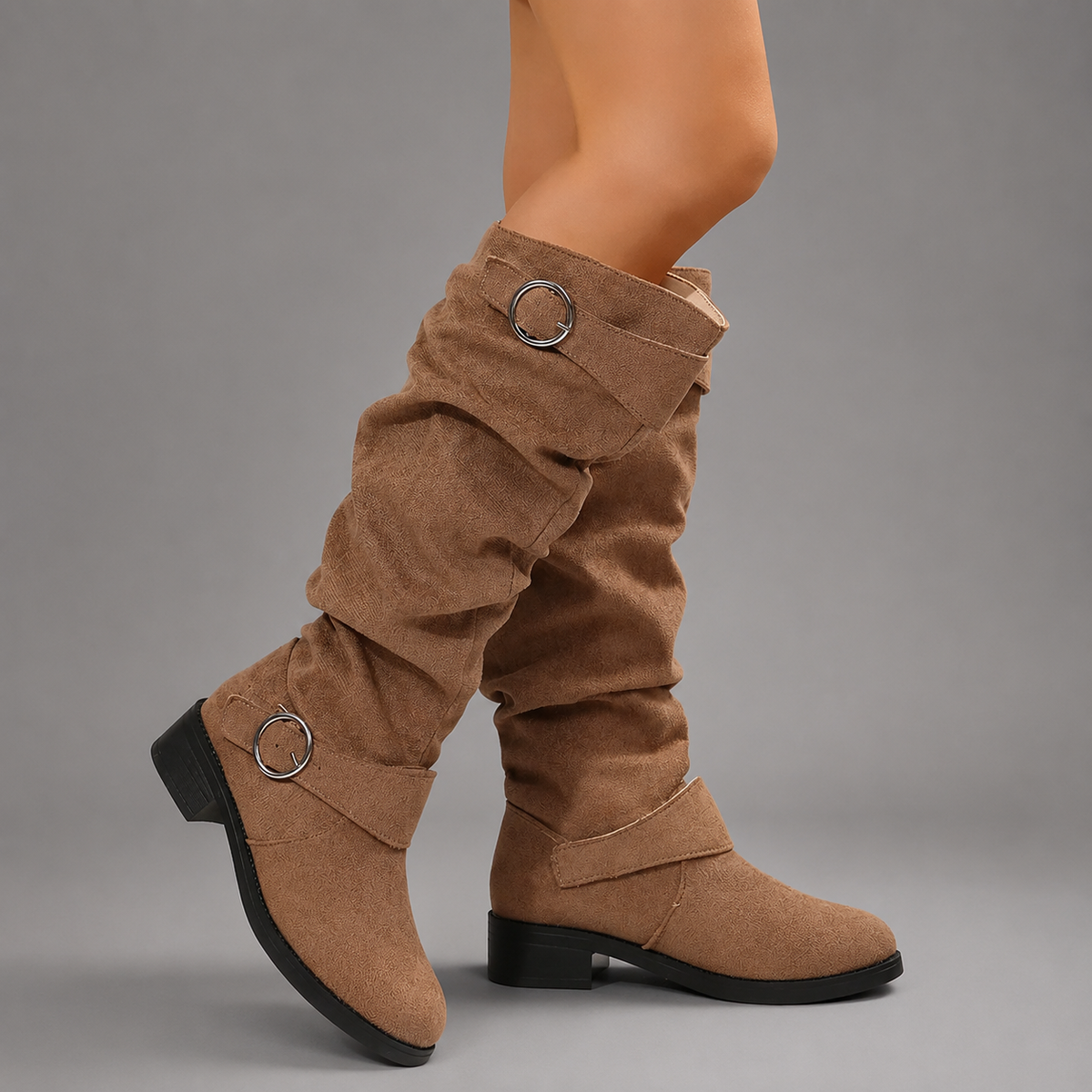 Women’s black slouch mid-calf boots with decorative buckle accents, relaxed shaft, slip-on design, soft textile lining, and durable rubber outsole.