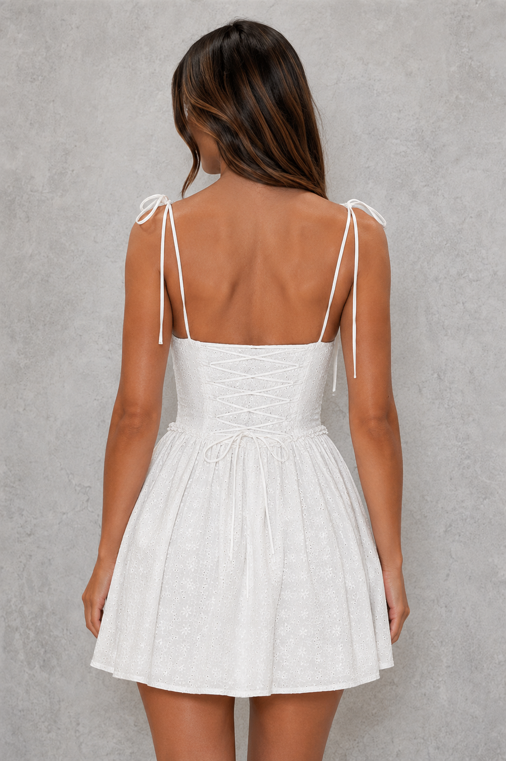 Women's broderie anglaise corset mini dress featuring a structured boned bodice, underwired gathered cups, adjustable shoulder ties, lace-up back, and a full flared skirt, crafted from breathable cotton for summer parties, brunches, and special occasions.
