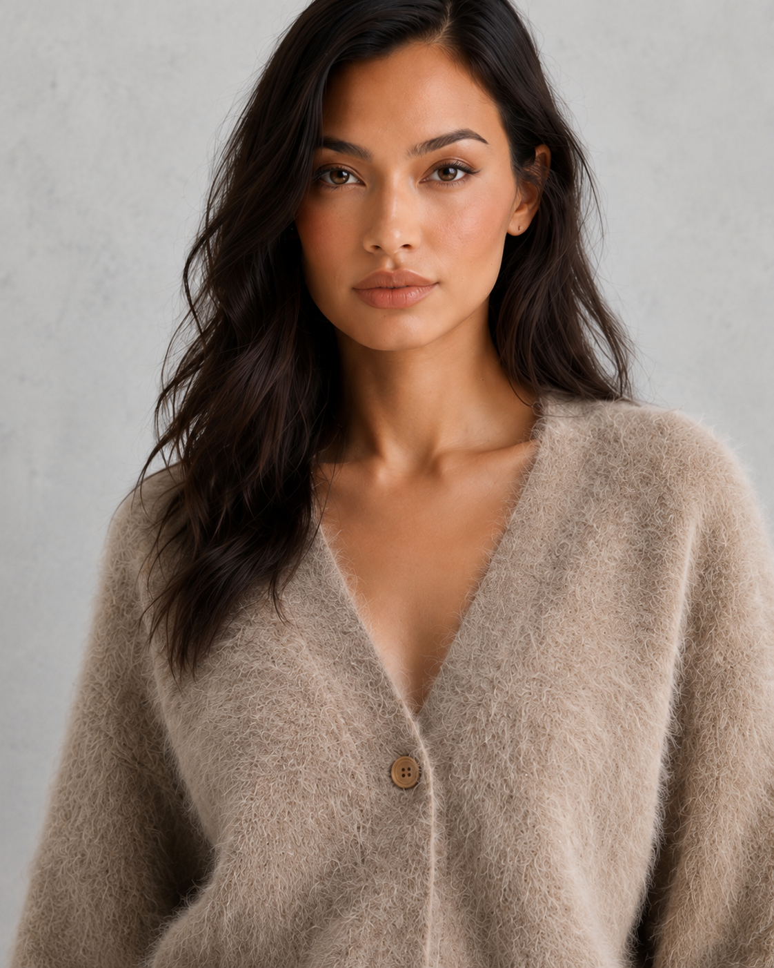 Woman wearing a soft button-front knit cardigan in a relaxed fit, styled for elegant autumn and winter layering.