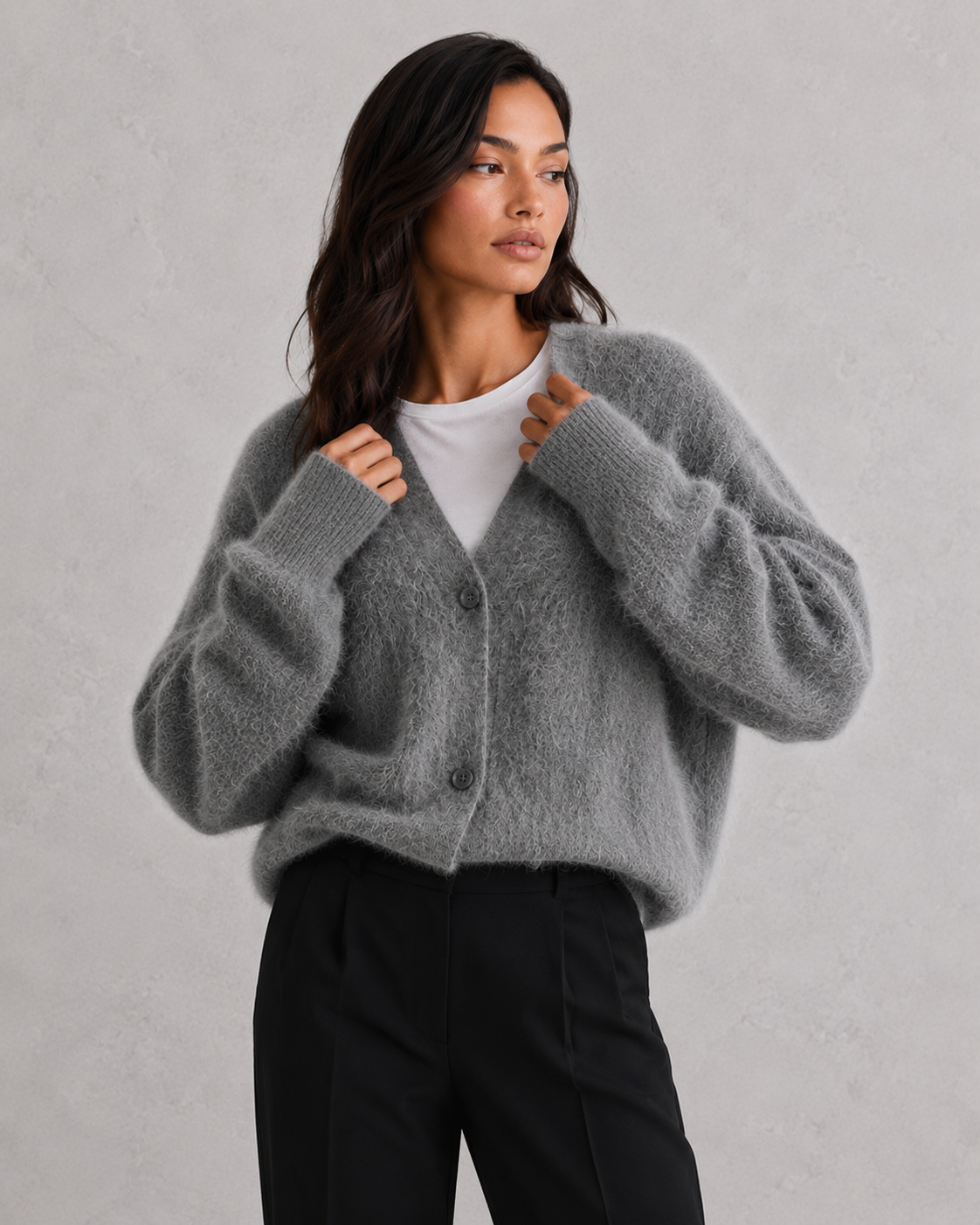 Woman wearing a soft button-front knit cardigan in a relaxed fit, styled for elegant autumn and winter layering.