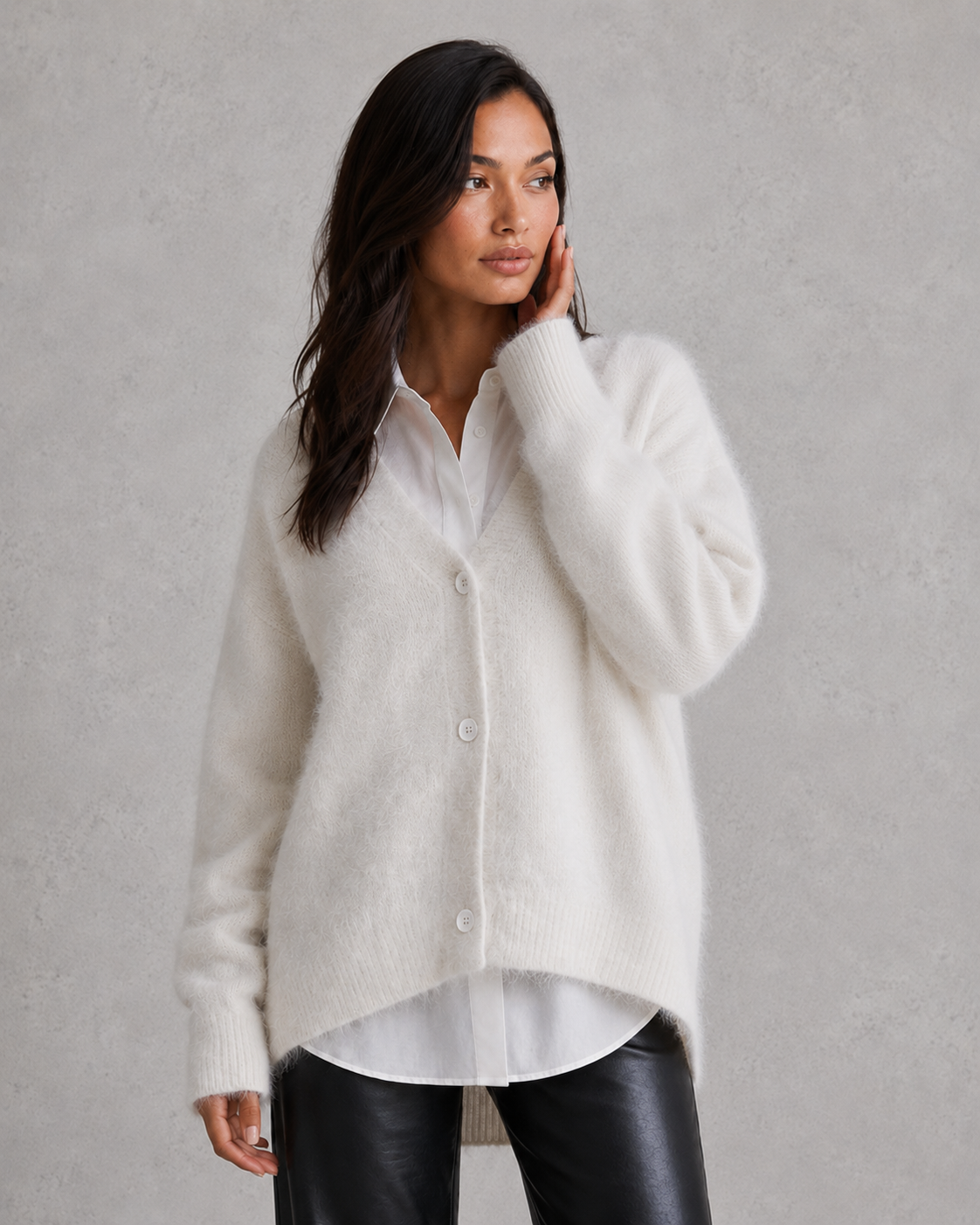 Woman wearing a soft button-front knit cardigan in a relaxed fit, styled for elegant autumn and winter layering.