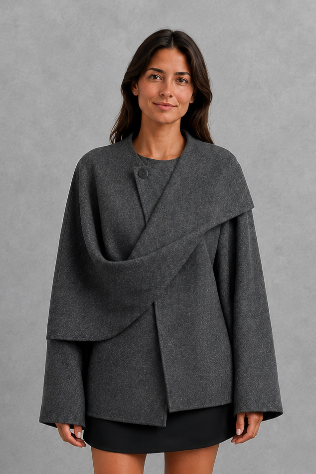 Women’s cape-style longline coat with a built-in scarf, flowing relaxed silhouette, soft cozy fabric, and elegant cold-weather design.