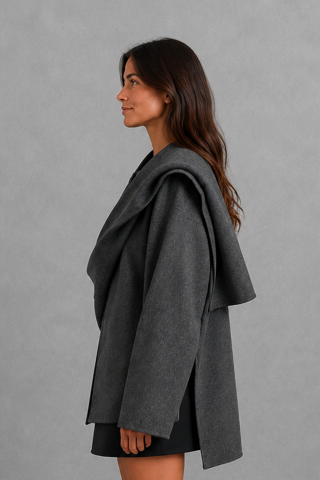 Women’s cape-style longline coat with a built-in scarf, flowing relaxed silhouette, soft cozy fabric, and elegant cold-weather design.