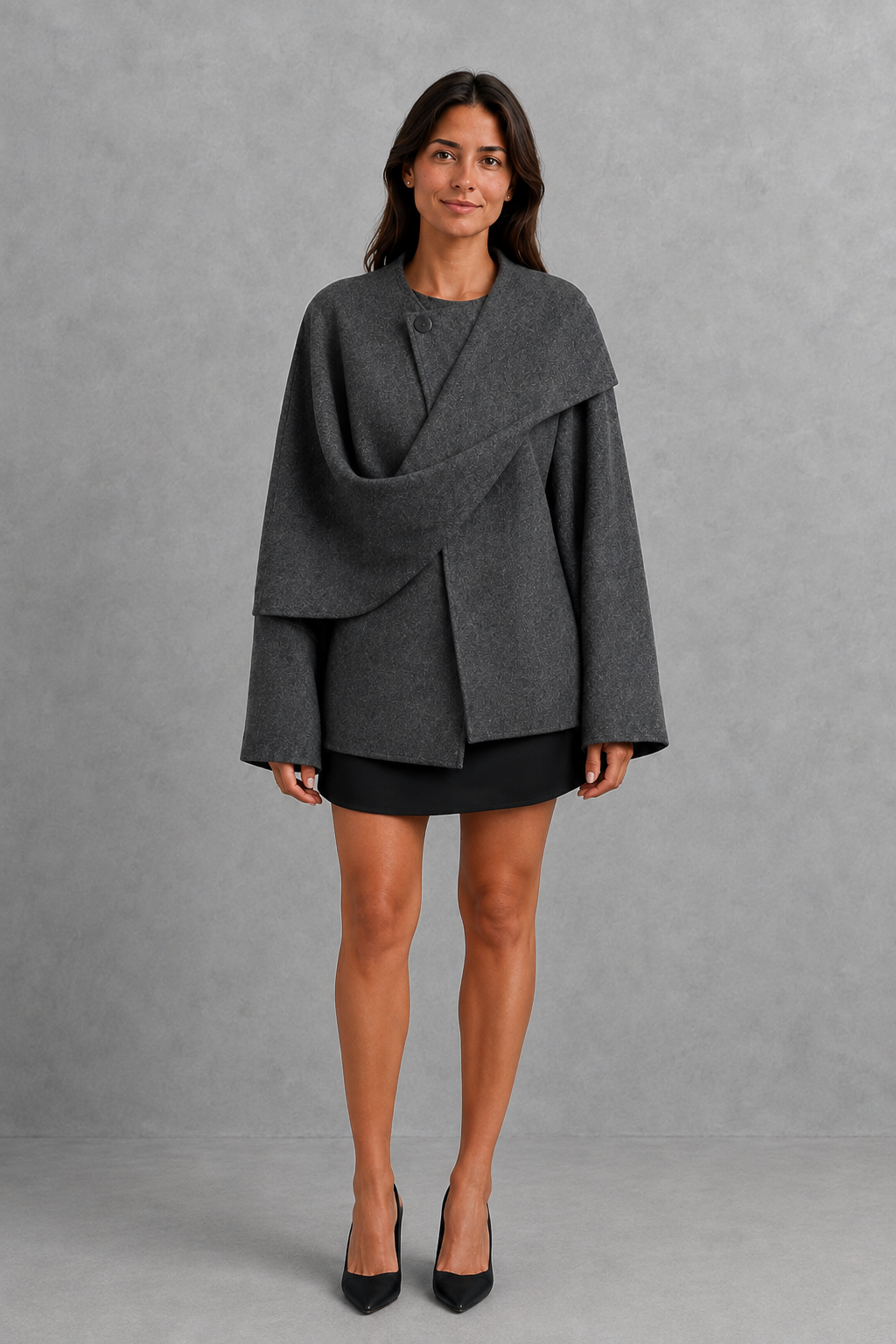 Women’s cape-style longline coat with a built-in scarf, flowing relaxed silhouette, soft cozy fabric, and elegant cold-weather design.