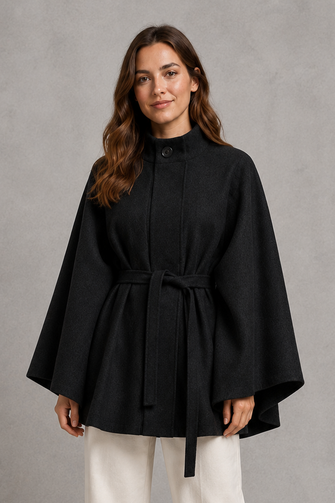 Women’s cape sleeve wool-look coat with a refined stand collar, belted waist, slim tailored fit, and structured statement silhouette.